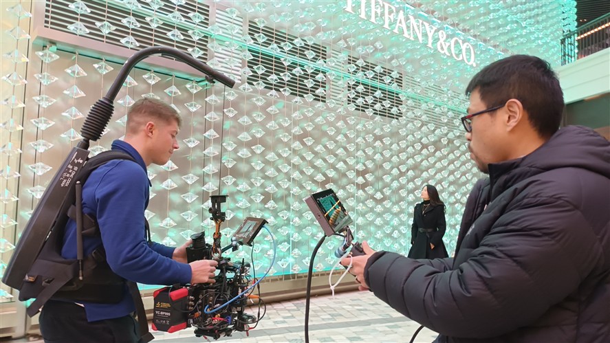Guangzhou production crew preparing camera and lighting gear inside a stylized interior location
